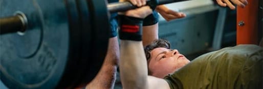 teen bench pressing class at the gym