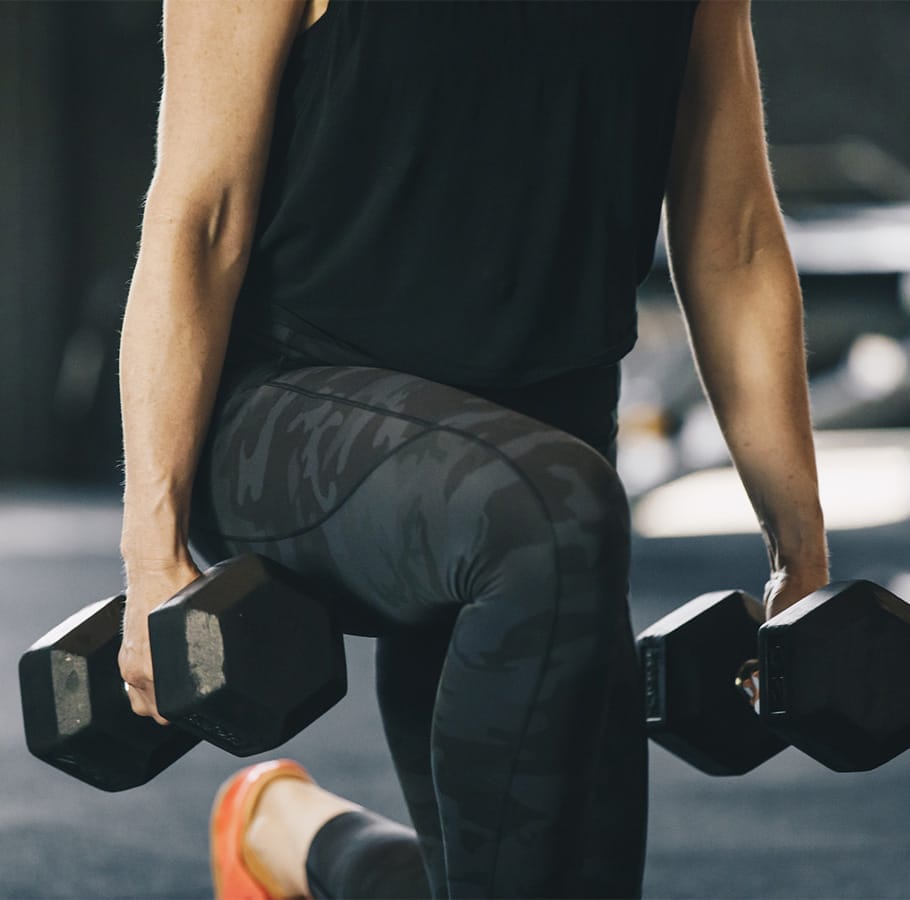 woman doing leg extentions with dumbbells